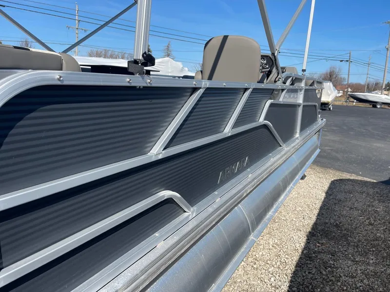 Slide: The Image of 2025 Armada Saphir 23CR pontoon boat, sleek design, parked outdoors on gravel. - 5