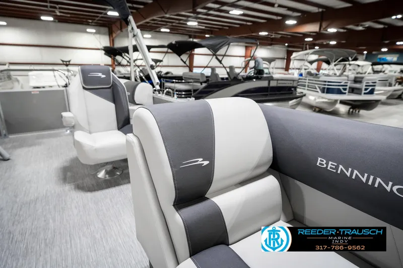 Slide: The Image of 2025 Bennington 20 SSR boat interior with gray seating in showroom. - 24