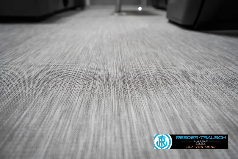 Slide: The Image of 2025 Bennington 20 SSR interior flooring with textured design, featuring Reeder-Trausch Marine branding. - 46
