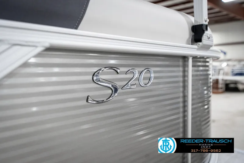 Slide: The Image of 2025 Bennington 20 SSR boat with "S20" emblem, showcased in a showroom. - 49