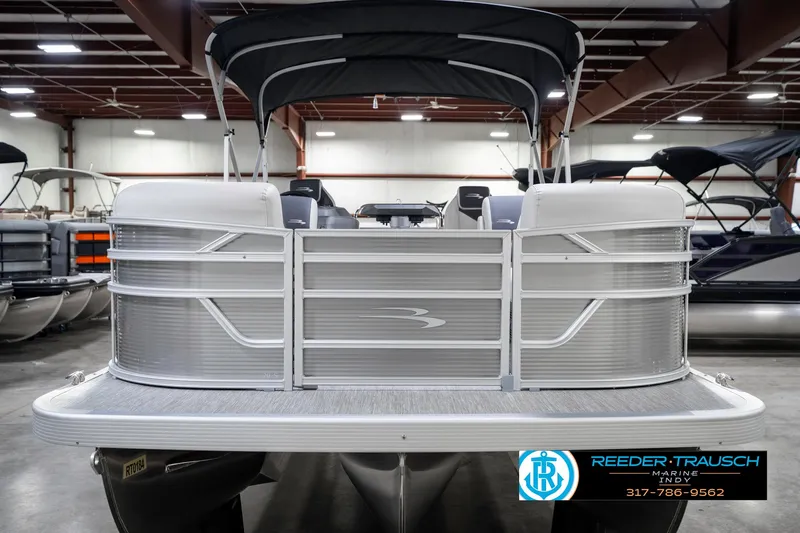 Slide: The Image of 2025 Bennington 20 SSR pontoon boat in showroom, front view with canopy. - 5