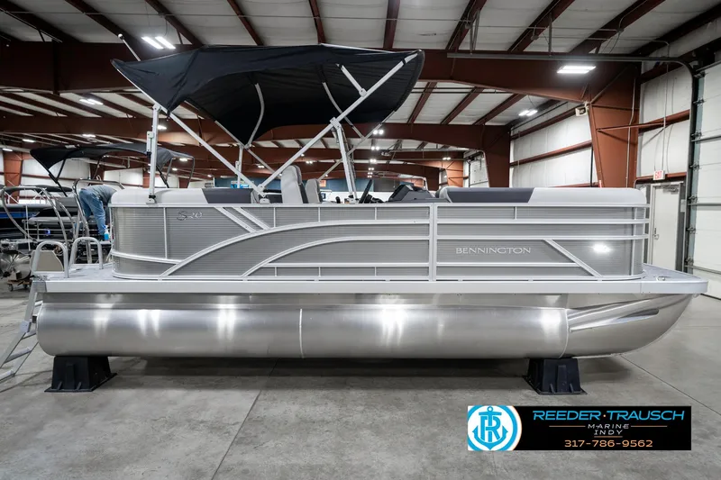 Slide: The Image of 2025 Bennington 20 SSR pontoon boat in showroom with canopy and sleek design. - 7