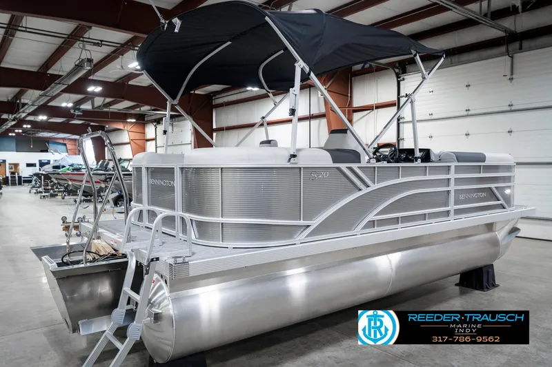 Slide: The Image of 2025 Bennington 20 SSR pontoon boat in showroom with canopy and sleek design. - 8
