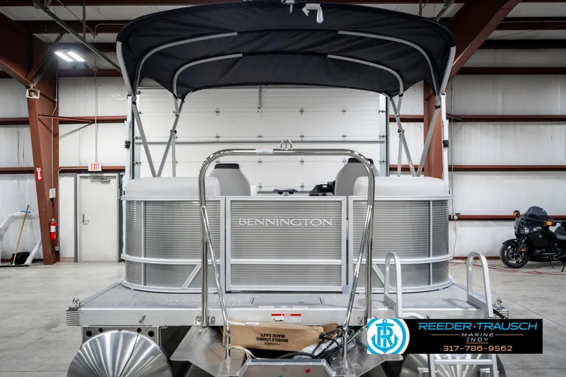 Slide: The Image of 2025 Bennington 20 SSR pontoon boat in a warehouse setting. - 9