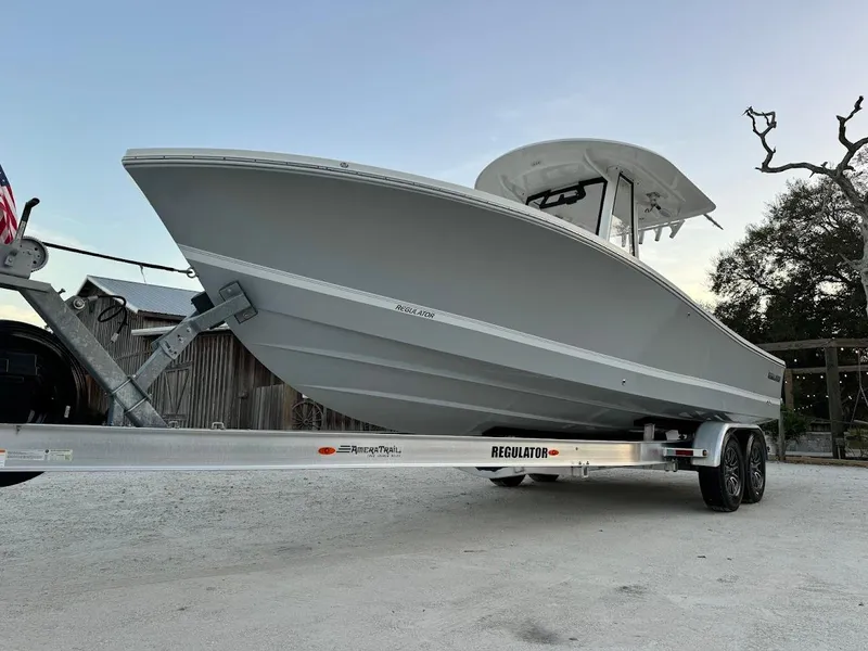 Slide: The Image of 2020 Regulator 26XO boat on trailer, side view, outdoors. - 11