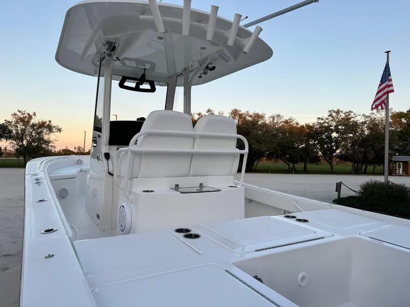 Slide: The Image of 2020 Regulator 26XO boat with T-top, white seating, and American flag in background. - 15