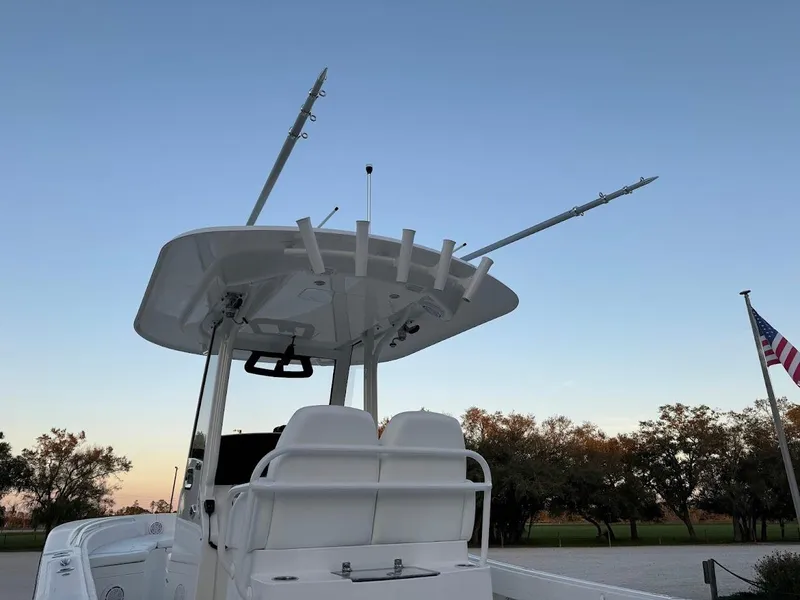 Slide: The Image of 2020 Regulator 26XO boat with fishing rod holders at sunset. - 16
