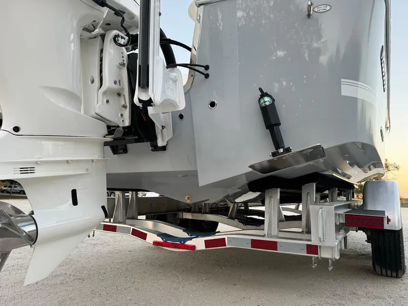Slide: The Image of 2020 Regulator 26XO boat on trailer, showcasing hull and outboard motor details. - 18