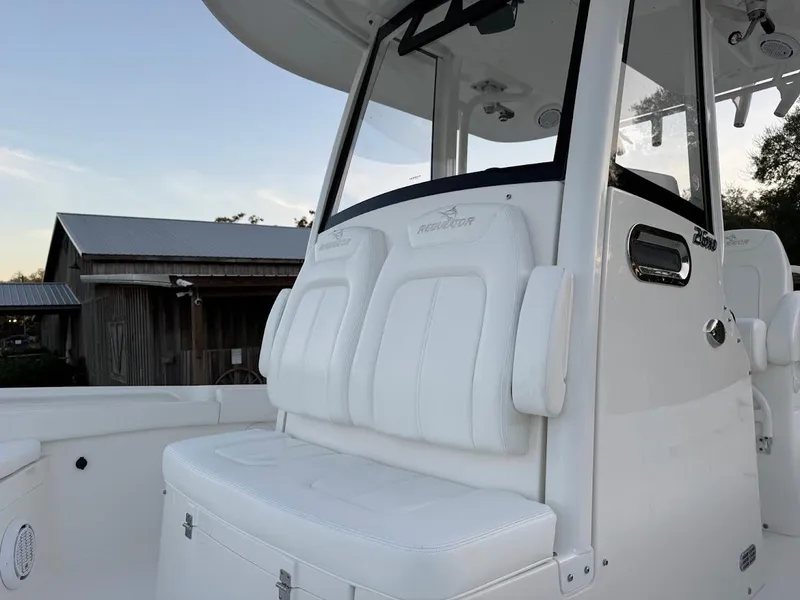 Slide: The Image of 2020 Regulator 26XO boat with white seating and console, showcasing modern design. - 25