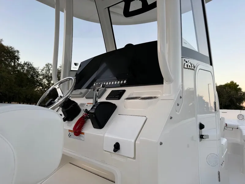 Slide: The Image of 2020 Regulator 26XO boat console with steering wheel and controls, featuring sleek design. - 28