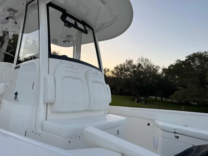 Slide: The Image of 2020 Regulator 26XO boat interior with seating and console at sunset. - 31