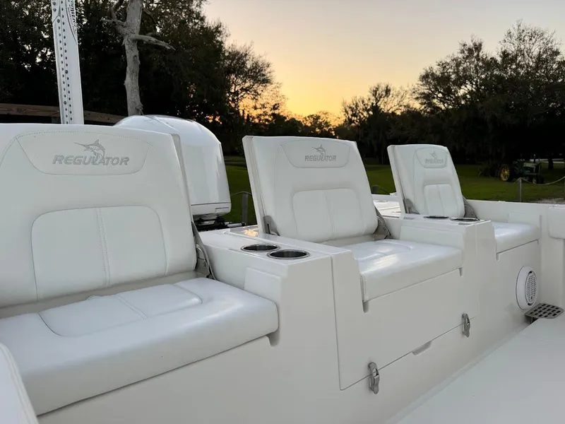 Slide: The Image of 2020 Regulator 26XO boat seats at sunset, featuring white leather upholstery. - 35