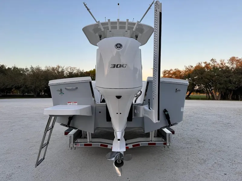 Slide: The Image of 2020 Regulator 26XO boat on trailer, rear view with outboard motor. - 4