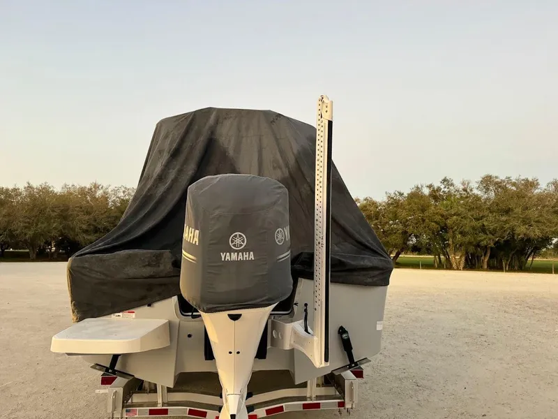 Slide: The Image of 2020 Regulator 26XO boat with Yamaha engine, covered and parked outdoors. - 41