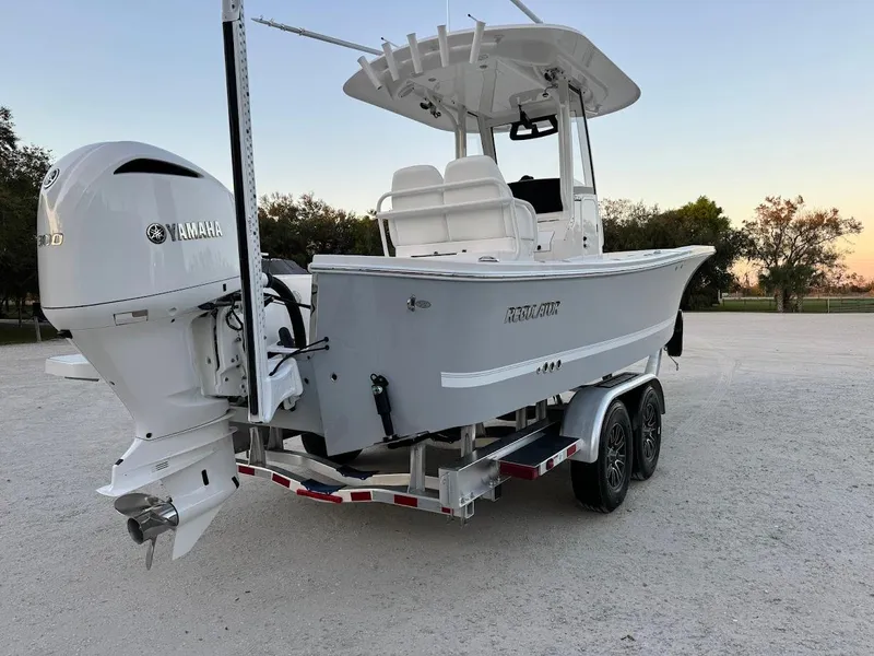 Slide: The Image of 2020 Regulator 26XO boat with Yamaha engine on a trailer at sunset. - 5