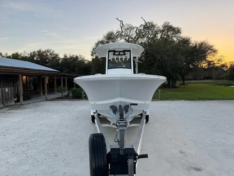 Slide: The Image of 2020 Regulator 26XO boat on trailer, parked outdoors at sunset. - 9