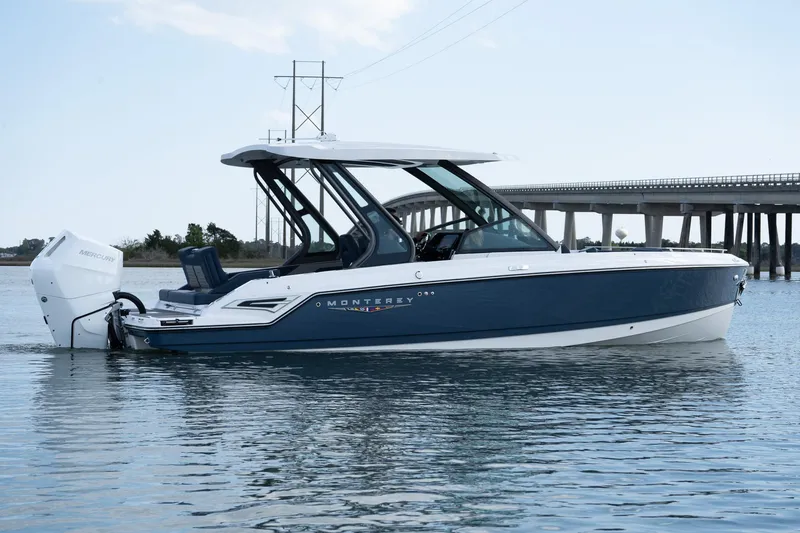 The Image of 2025 Monterey Elite 27 OB boat on water, side view, near a bridge. - 0
