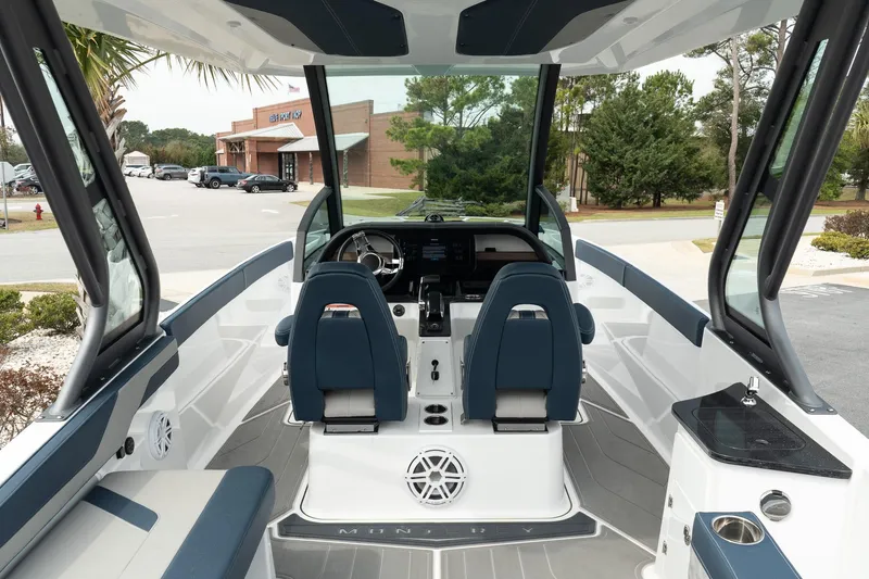 Slide: The Image of 2025 Monterey Elite 27 OB boat interior with modern seating and dashboard. - 13