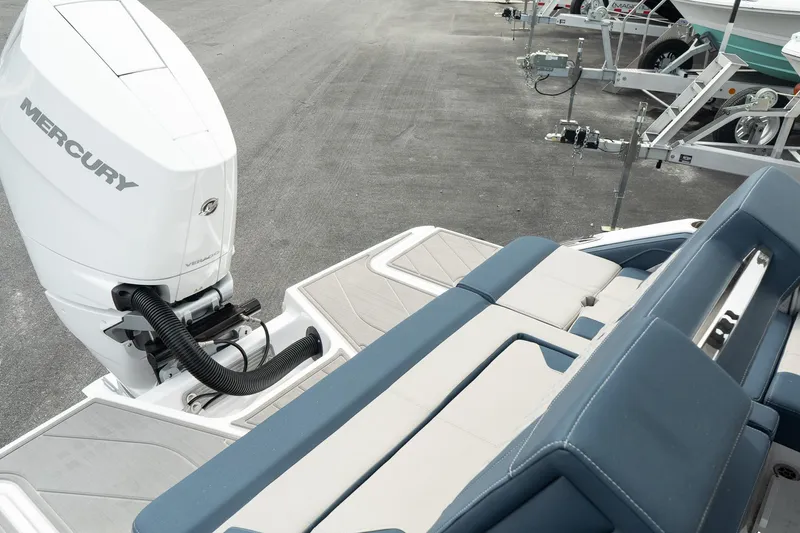 Slide: The Image of 2025 Monterey Elite 27 OB boat with Mercury outboard engine and blue seating. - 20