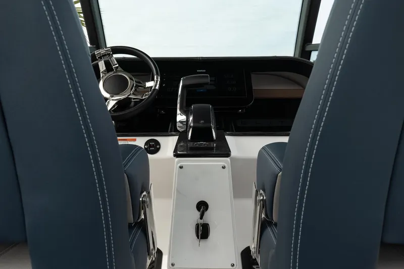 Slide: The Image of 2025 Monterey Elite 27 OB boat interior with modern steering and controls. - 22