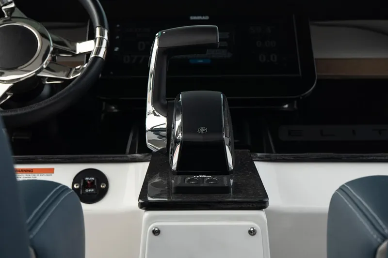 Slide: The Image of 2025 Monterey Elite 27 OB boat dashboard with modern steering and control panel. - 23