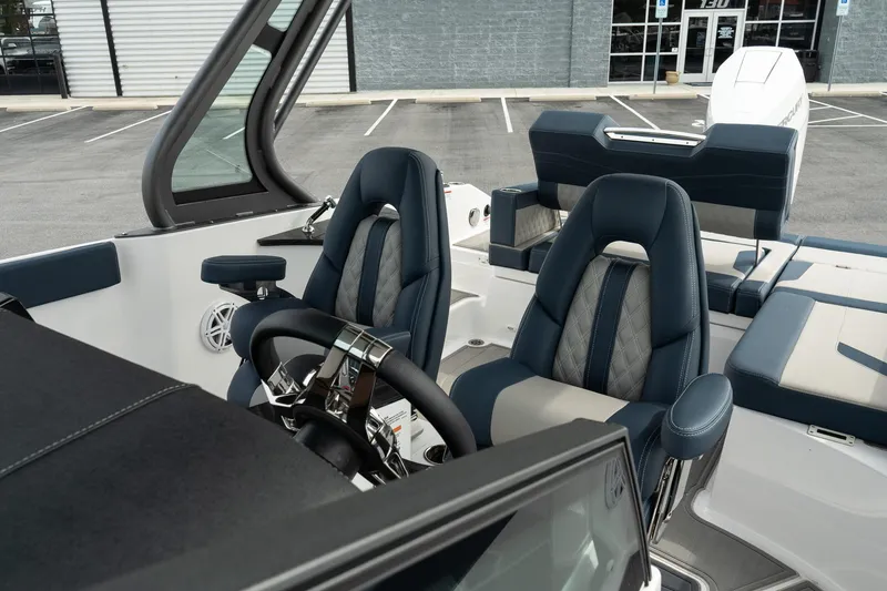Slide: The Image of 2025 Monterey Elite 27 OB boat interior with modern seating and steering wheel. - 24
