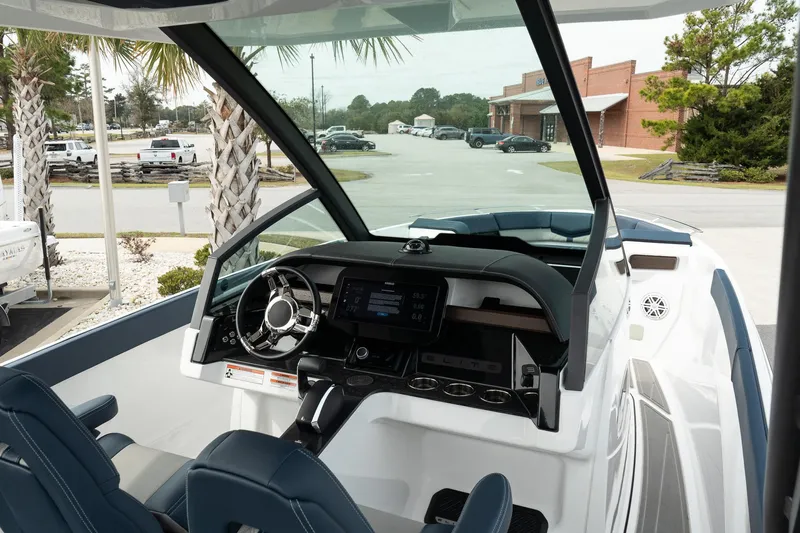 Slide: The Image of 2025 Monterey Elite 27 OB boat interior with modern dashboard and steering wheel. - 25