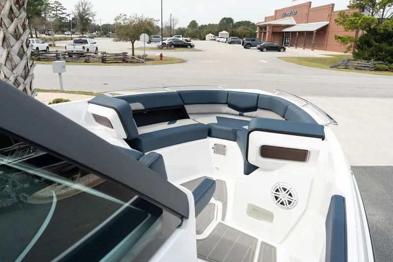 Slide: The Image of 2025 Monterey Elite 27 OB boat with spacious seating in a parking lot setting. - 27