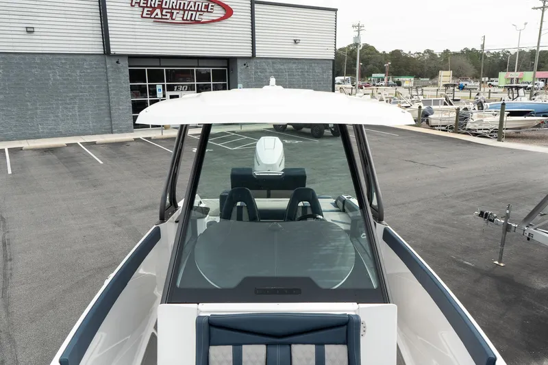 Slide: The Image of 2025 Monterey Elite 27 OB boat at dealership, front view. - 28