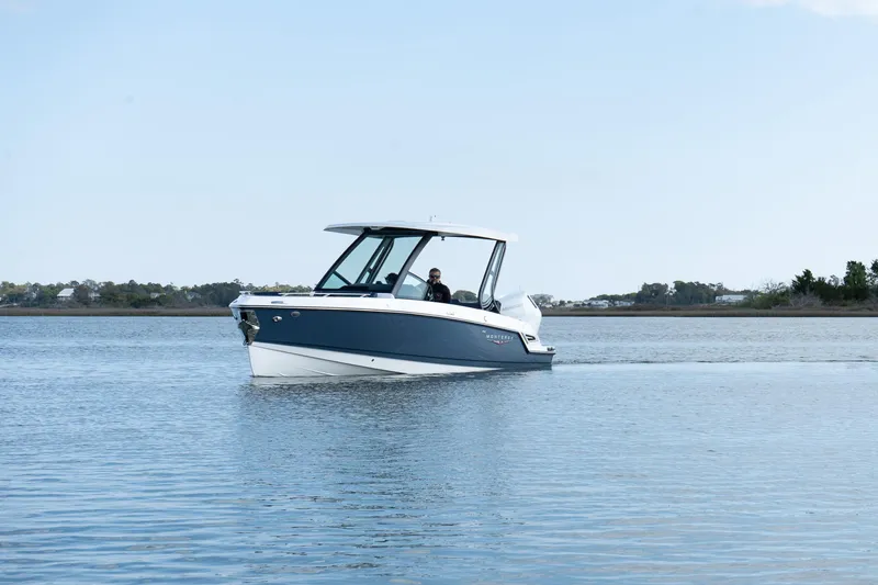 Slide: The Image of 2025 Monterey Elite 27 OB boat cruising on calm water. - 33