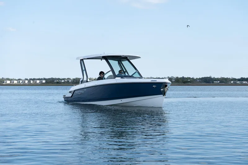 Slide: The Image of 2025 Monterey Elite 27 OB boat cruising on calm water. - 36