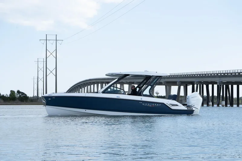 Slide: The Image of 2025 Monterey Elite 27 OB boat on water near a bridge. - 5
