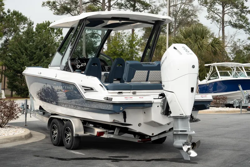 Slide: The Image of 2025 Monterey Elite 27 OB boat on trailer, featuring sleek design and powerful outboard motor. - 8