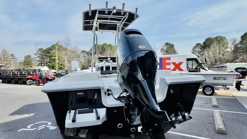 Slide: The Image of 2026 Bulls Bay 2200 XS boat with outboard motor in parking lot. - 4
