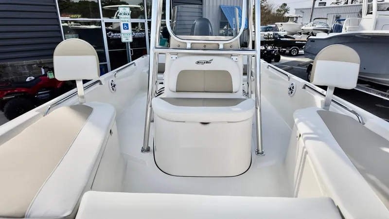 Slide: The Image of 2026 Bulls Bay 2200 XS boat interior with cushioned seating and console. - 6