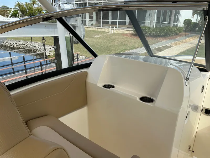 Slide: The Image of 2019 Scout 255 Dorado boat helm with steering wheel and control panel. - 11