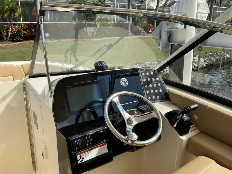 Slide: The Image of 2019 Scout 255 Dorado boat interior with beige seating and cup holders. - 12