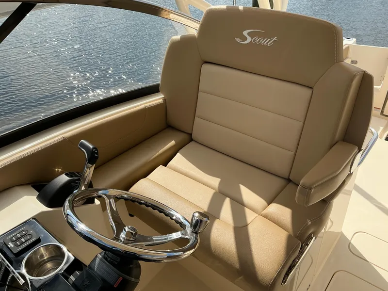 Slide: The Image of 2019 Scout 255 Dorado boat dashboard with steering wheel and control panel. - 13