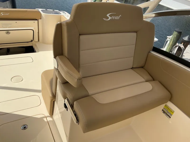 Slide: The Image of 2019 Scout 255 Dorado boat helm with beige seating and steering wheel. - 14