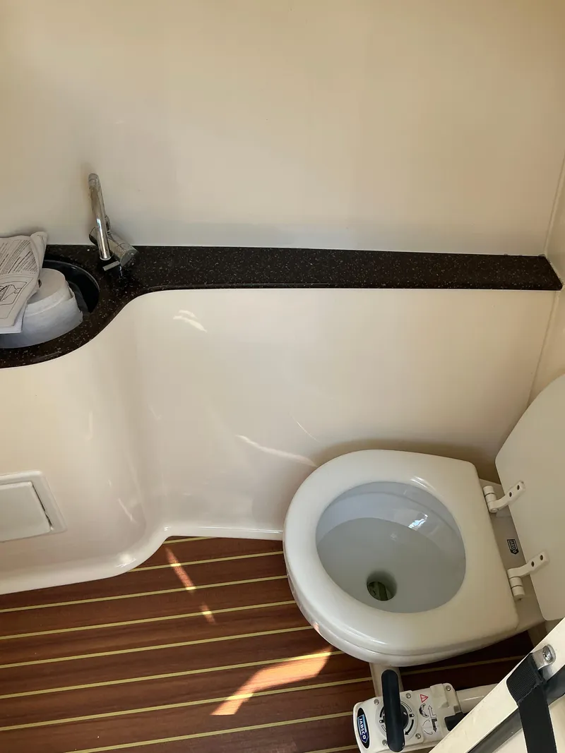 Slide: The Image of 2019 Scout 255 Dorado boat seat with beige upholstery and logo. - 15