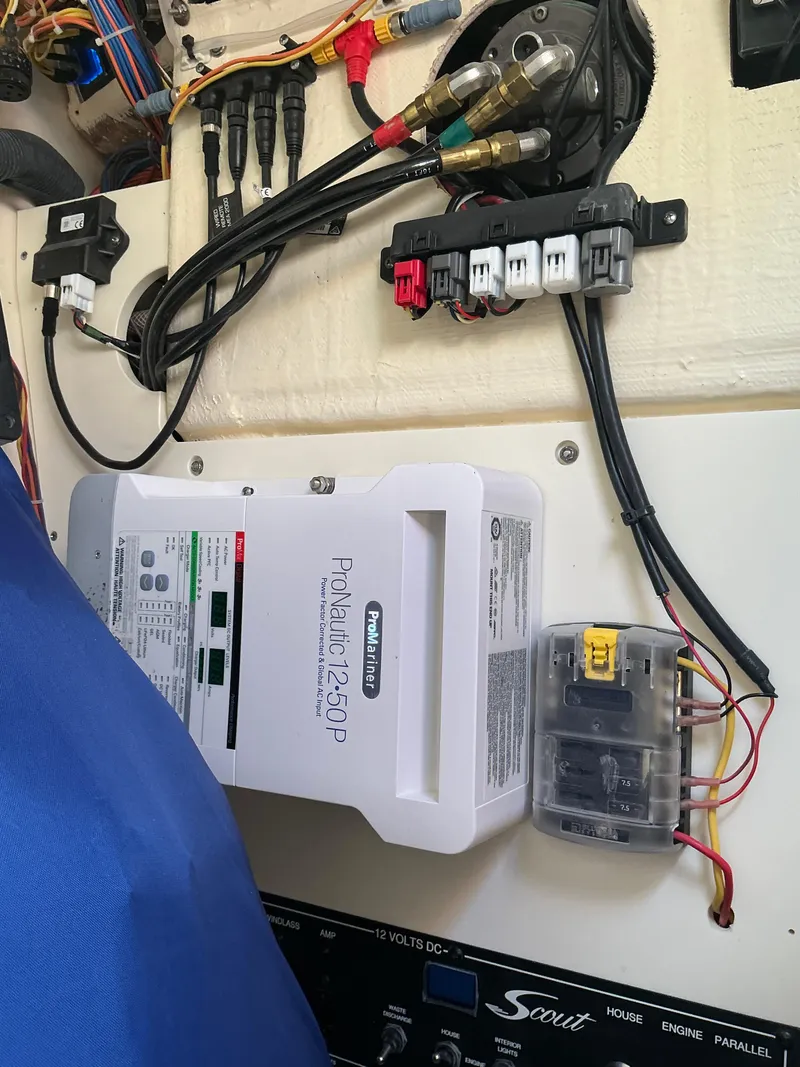 Slide: The Image of 2019 Scout 255 Dorado boat bathroom with toilet and sink, featuring wood-style flooring. - 16