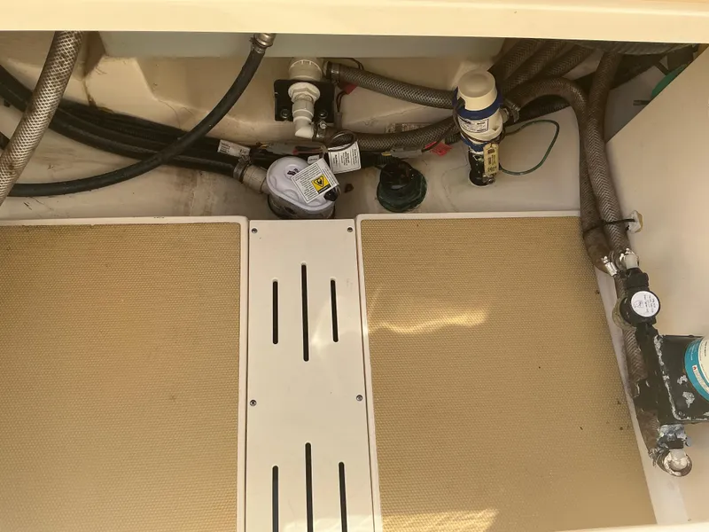 Slide: The Image of 2019 Scout 255 Dorado boat interior showing plumbing and equipment setup. - 25