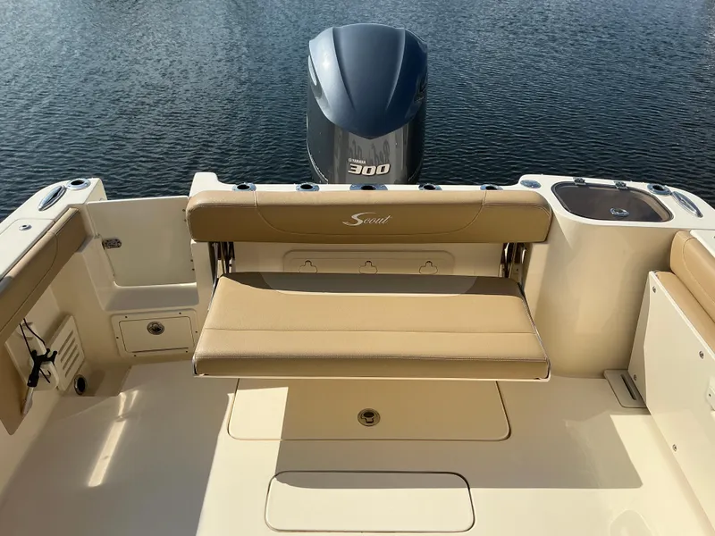 Slide: The Image of 2019 Scout 255 Dorado boat interior, featuring seating and storage near the water. - 27