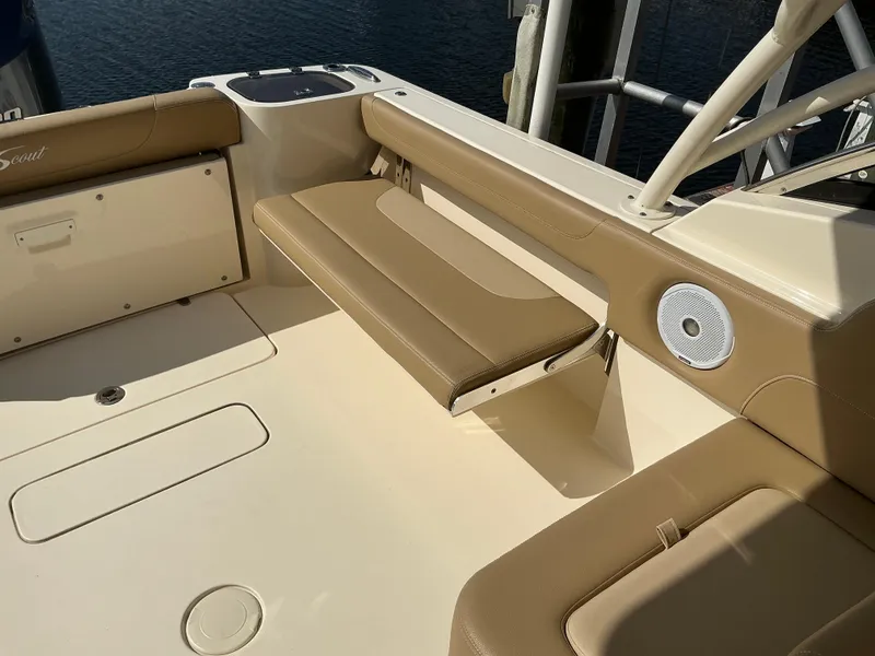 Slide: The Image of 2019 Scout 255 Dorado boat with Yamaha 300 engine, beige seating, and water backdrop. - 28