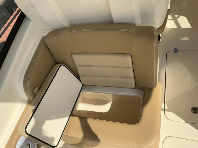 Slide: The Image of 2019 Scout 255 Dorado boat interior with tan seating and speaker. - 29