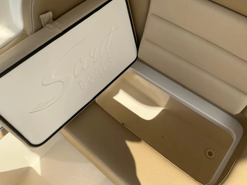 Slide: The Image of 2019 Scout 255 Dorado boat seat with beige upholstery and integrated storage. - 30