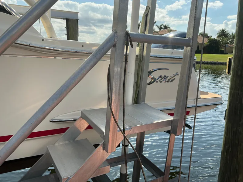 Slide: The Image of 2019 Scout 255 Dorado boat docked near water with palm trees in background. - 34