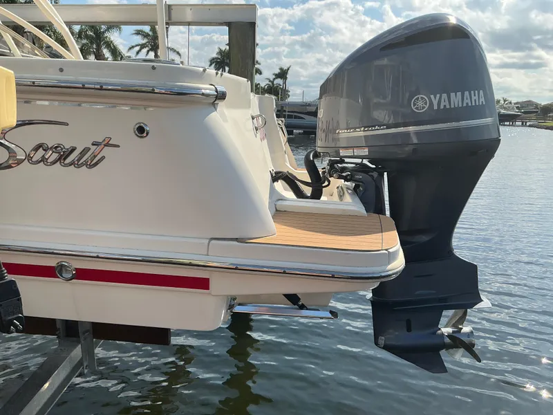 Slide: The Image of 2019 Scout 255 Dorado boat docked near metal stairs by the water. - 35