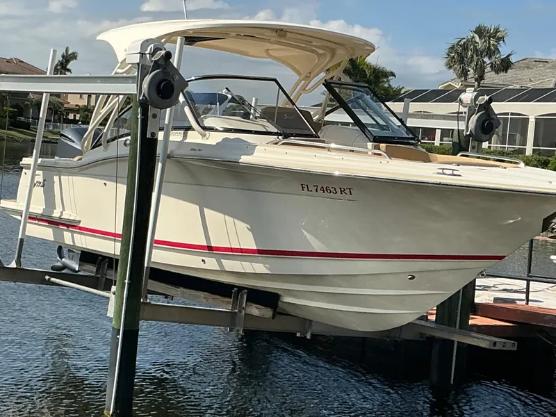 Slide: The Image of 2019 Scout 255 Dorado boat on lift by waterfront homes. - 44