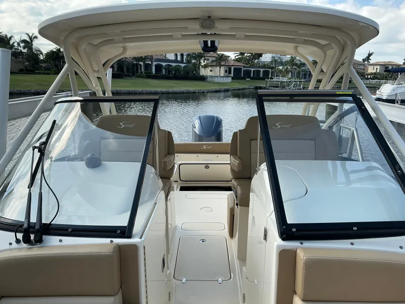Slide: The Image of 2019 Scout 255 Dorado boat interior with beige seating and speakers. - 5